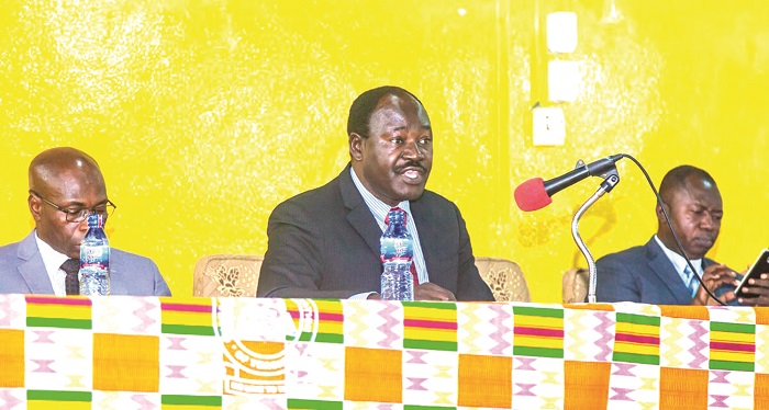 Mr Michael Mba Allan (middle) a board member, addressing the meeting.